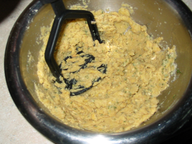 Mashing the chickpeas and other ingredients in a bowl