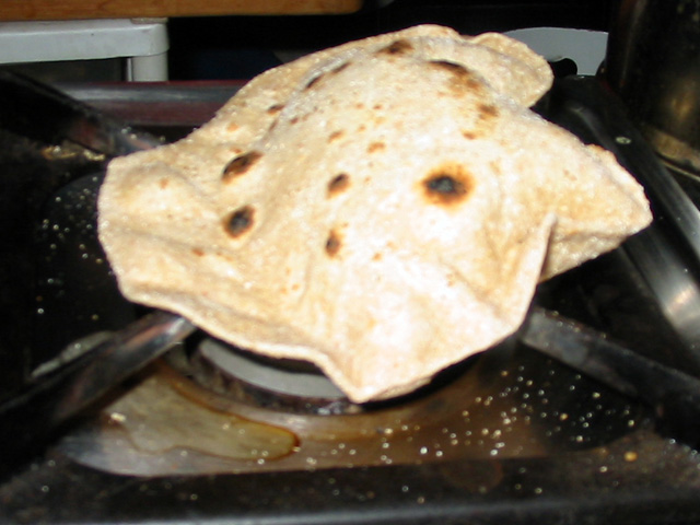 Puffing the Roti over open flame